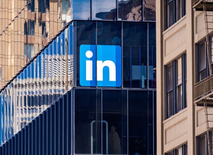 The LinkedIn logo on the side of a dark windowed building.