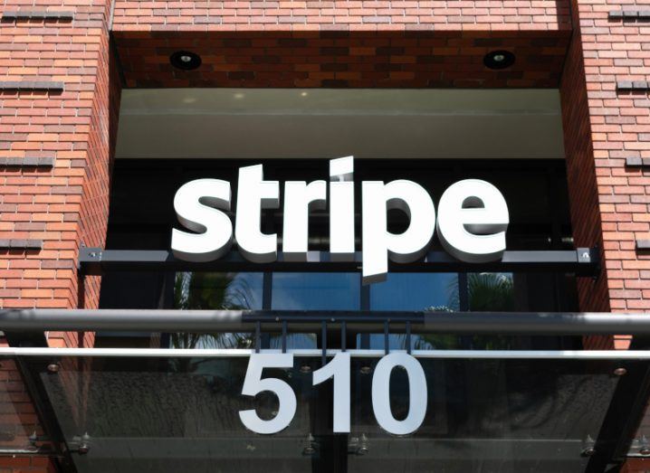 The Stripe logo on the front of a building, with the number 510 hanging under it.