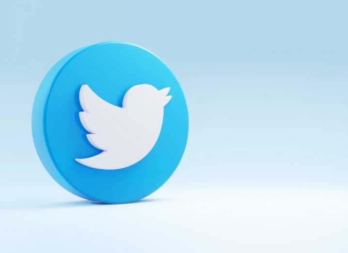 Illustration of the Twitter logo on a white surface, with a light blue background.