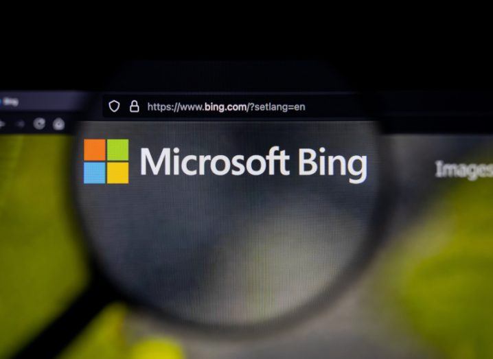 A magnifying glass over the Microsoft Bing logo on a computer screen.