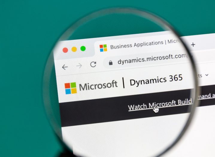 Magnifying glass hovering over a search engine page with Microsoft 365 Dynamics open.