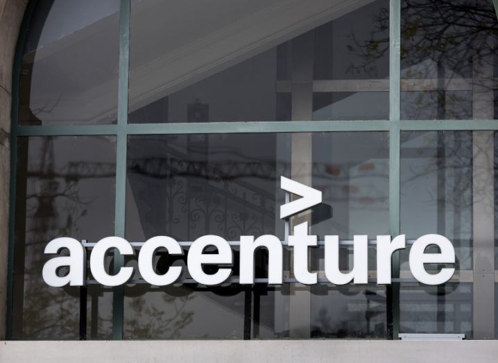 The glass front of a building with the Accenture logo on it.