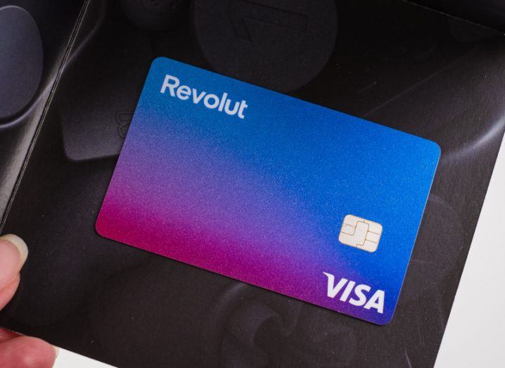 A credit card with the Revolut logo on the top left and a Visa logo on the bottom right.