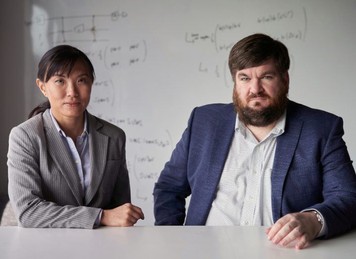 Dr Si-Hui Tan and Dr Joe Fitzsimons of Horizon Quantum Computing sit next to each other at a desk.