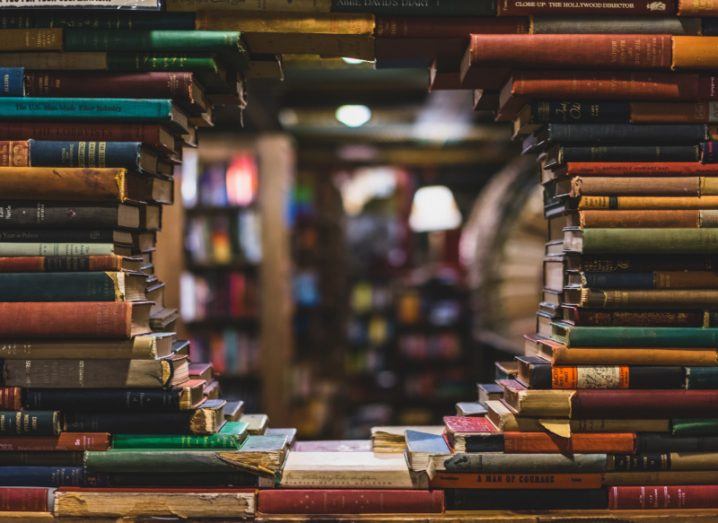 Image of books piled up to form circular gap in the middle.