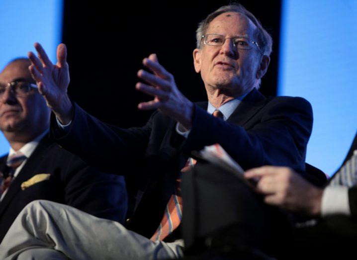 Image of George Gilder speaking on stage at a conference.