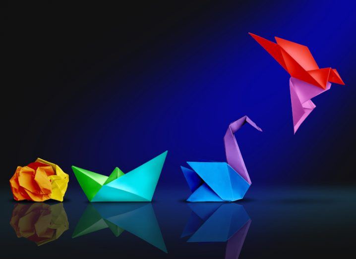 Colourful image of crumpled paper transformed into boat, swan and then bird in flight to symbolise gradual transformation.