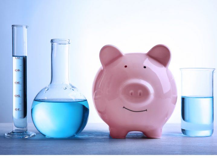 Piggy bank with liquid in different beakers that are used in science experiments.