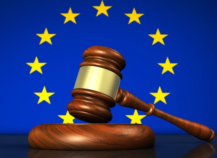 The EU flag with a judge's gavel in front of it in a legal concept.