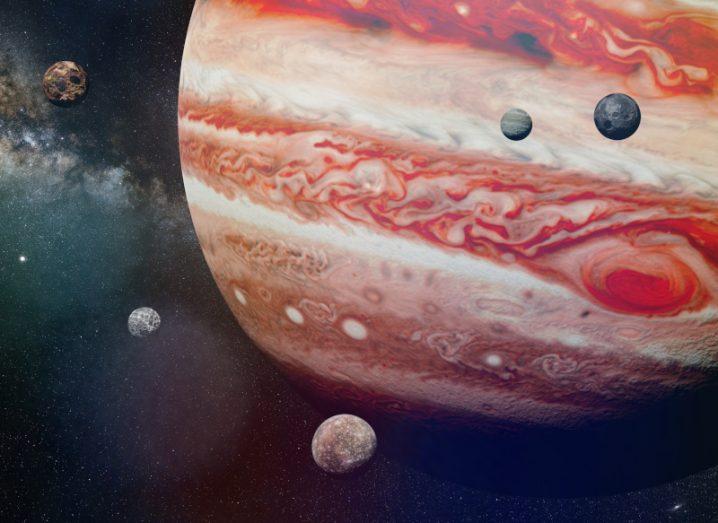 Artistic rendering of planet orange-yellow Jupiter and some of its moons.
