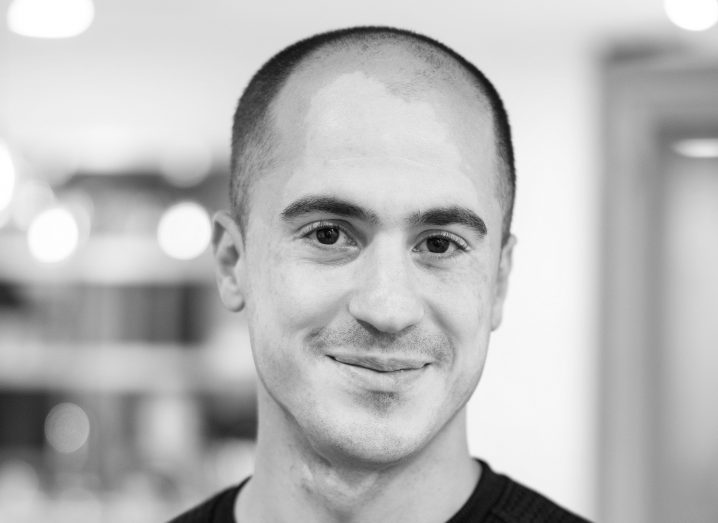 Headshot of Ryan Lasmaili, CEO and co-founder of Vaultree. The photo is in black and white and the background is blurred. Subject is looking at the camera and smiling.