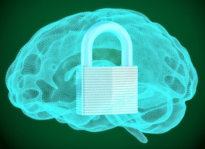 A large padlock sits in a blue outline of a human brain against a green background, symbolising a cybersecurity mindset.