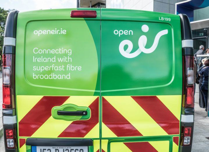 A green van with writing and the Eir logo on the back.
