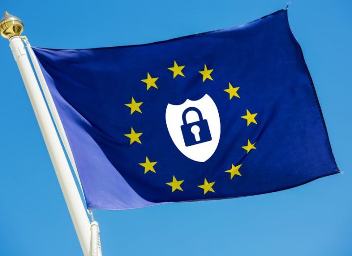 The EU flag with a shield and lock logo in the centre and a blue sky in the background.