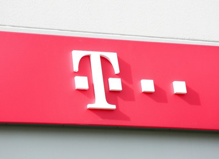 T-Mobile logo with the letter T and dots in white on a bold pink background.