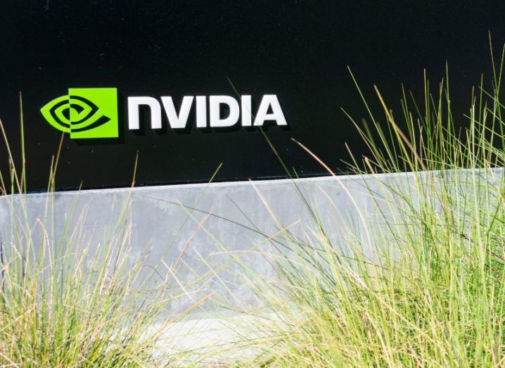 Nvidia logo on a sign on the side of a building with grass growing in front of it.