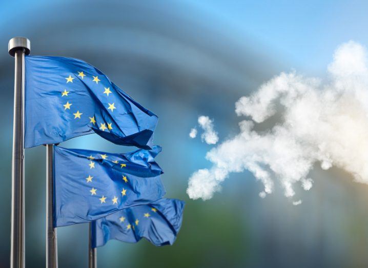 Three EU flags next to a cloud that is in the shape of Europe.