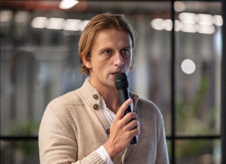 A man wearing a tan jumper holding a microphone. He is Nik Storonsky, CEO of Revolut.