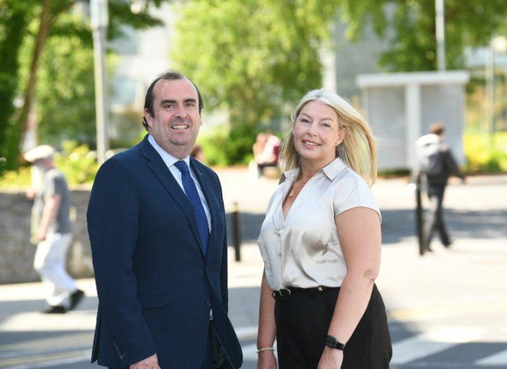A man and a woman stand next to each other in the outdoors and pose for a photograph. They're both involved with the launch of the Institute for Clinical Trials in Ireland.,