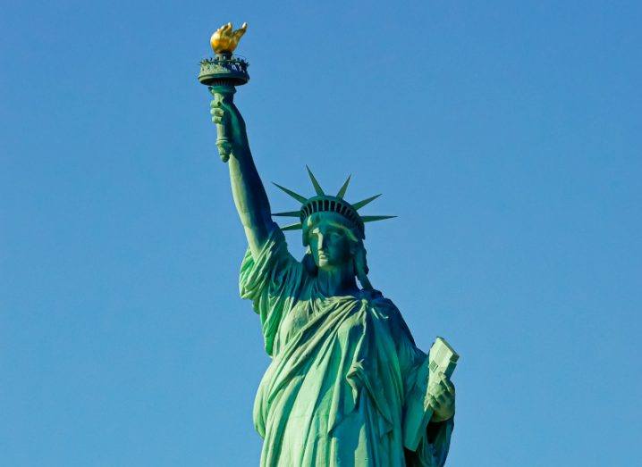 The Statue of Liberty against a clear blue sky.