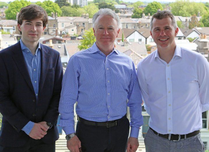 The two founders of Epicapture and the founder of Medwrite standing in front of a view of a housing estate.