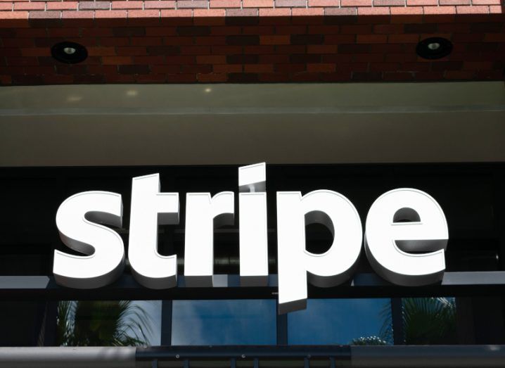 The Stripe company logo in front of a building window.