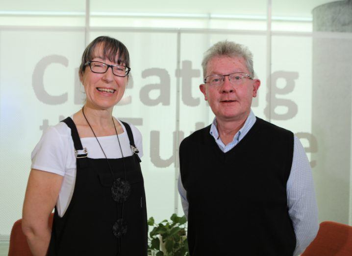 A woman and a man stand side by side smiling at the camera. They are Ann O’Dea and Prof Séamus Davis.