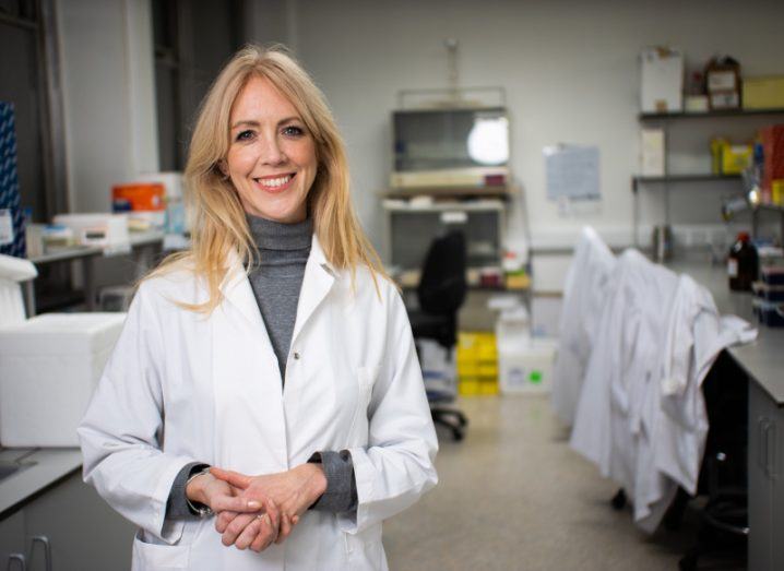 Headshot of Epicapture co-founder Dr Antoinette Perry wearing a white lab coat and standing inside a laboratory.