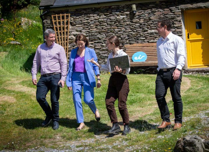 Two women and two men walk on grass in rural Kerry at the Eir 5G announcement.