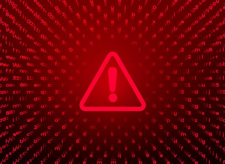 A red triangle with an exclamation mark inside and a red and black background with lines of code to symbolise cyberthreats.