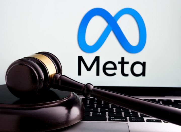 The Meta logo on a laptop screen, with a court gavel on the laptop keyboard.
