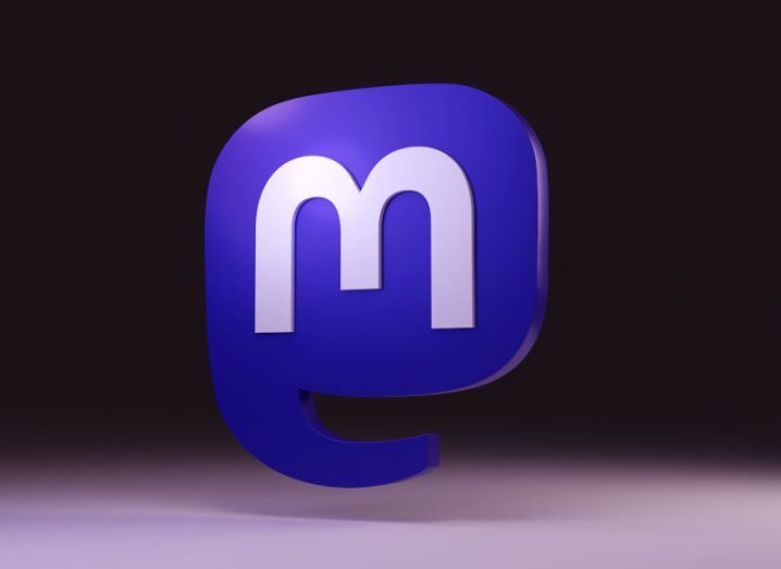 Illustration of a 3D Mastodon logo, floating above a grey surface in a dark background.