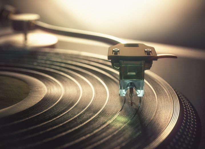 Illustration of a vinyl record being played on a vintage device.