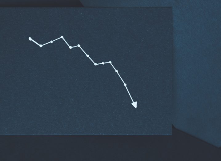 A white line on a piece of dark paper, pointing downwards. Used to show a decline.