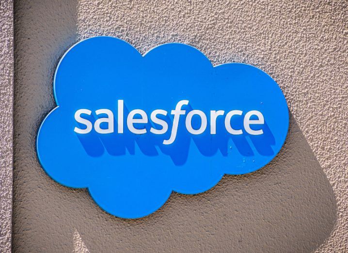 The Salesforce logo on the front of a brown wall.