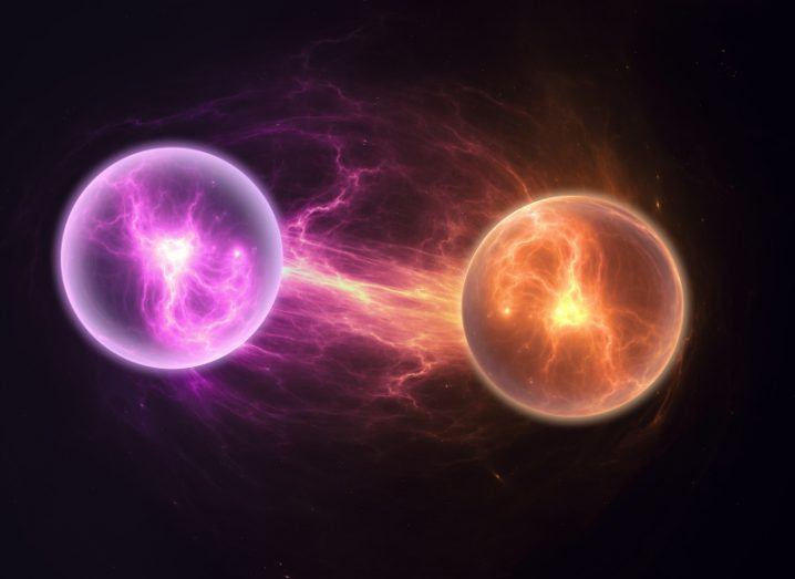 A purple orb and an orange orb next to each other in a dark background, connected to each other through a line of light. Used to represent quantum states and quantum chemistry.