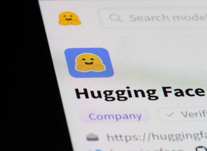 The Hugging Face logo on a smartphone screen.