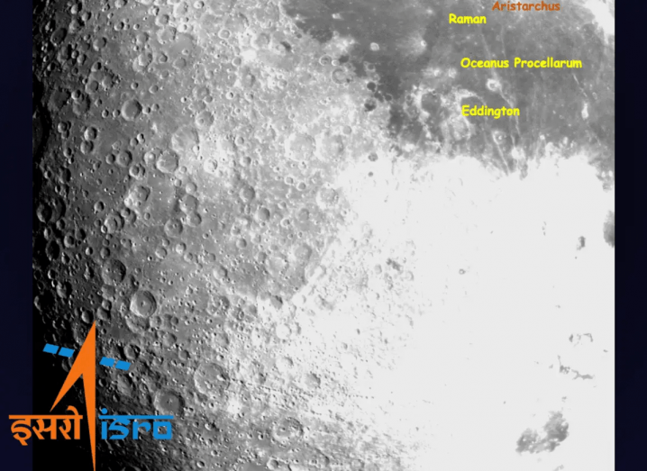 Image taken by Chandrayaan-3 of the moon's surface showing craters and crevices. ISRO logo in on the bottom left of the image.