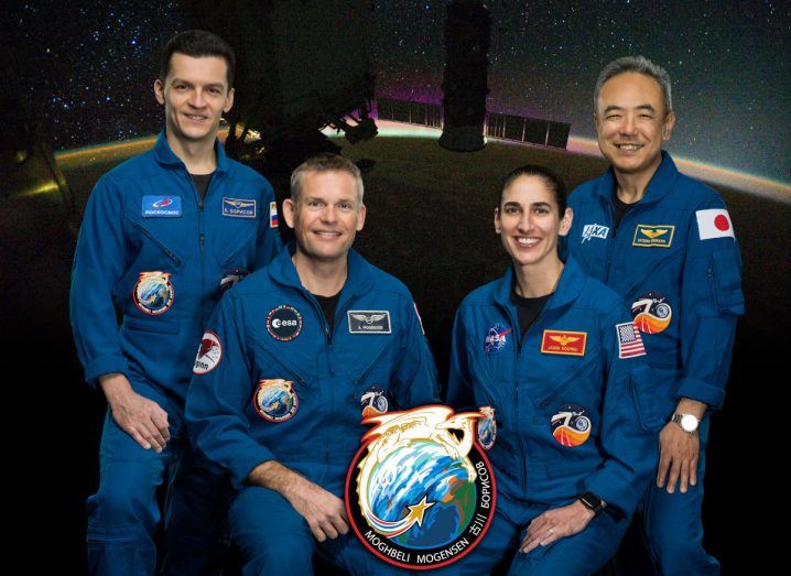 Team photo of the four Crew-7 astronauts who entered the ISS after being launched into space aboard a SpaceX rocket. The four are wearing blue spacesuits with their respective country flags on their arms.
