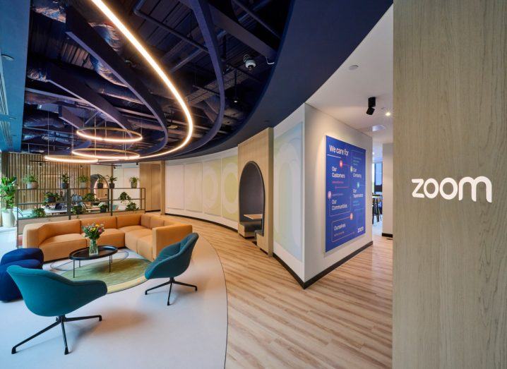 The interiors of the new Zoom London office with chairs and plants and overhead lighting.