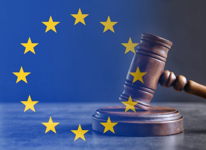 The EU flag with yellow stars on a blue background overlaid with a judge's gavel.