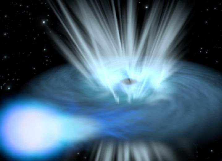 Illustration of a black hold sucking up a blue star, with gas and light swirling around the black hole.