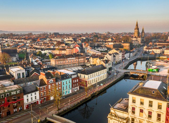 An aerial view of Cork city with a clear sky in the background.