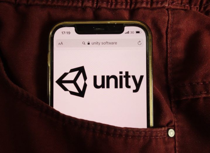 The Unity logo on a smartphone screen, inside someone's pocket.