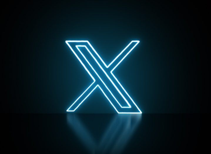 The X logo in neon blue, in a dark background. The site is owned by Elon Musk and used to be known as Twitter.