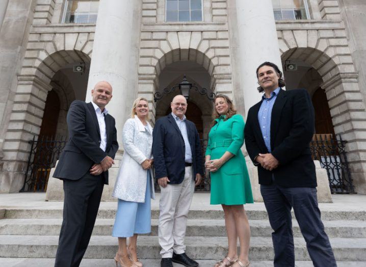 A group of three men and two women stand together at Trinity College Dublin to celebrate the launch of the IntegrityIQ spin-out project.