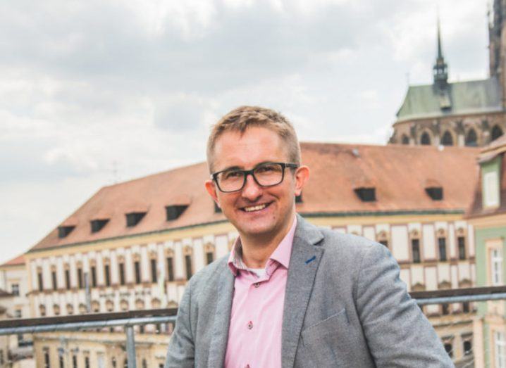 Headshot of Václav Potěšil, co-founder of Optellum, standing on high ground with buildings in the background.