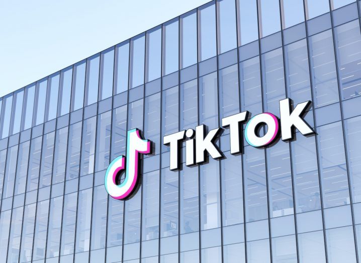 TikTok logo on a glass building.