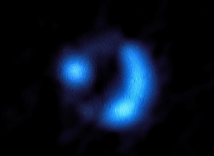 Image generated by the ALMA telescope of blue light amid pitch darkness, showing the magnetic field of the galaxy.