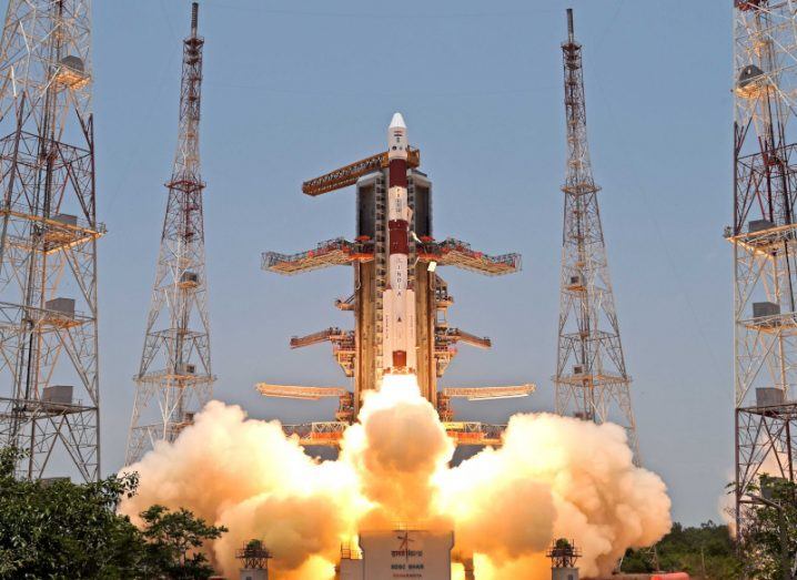 Aditya-L1 space craft launching. The craft points upwards as a plume of flames and smoke is released from the bottom to propel it into space.